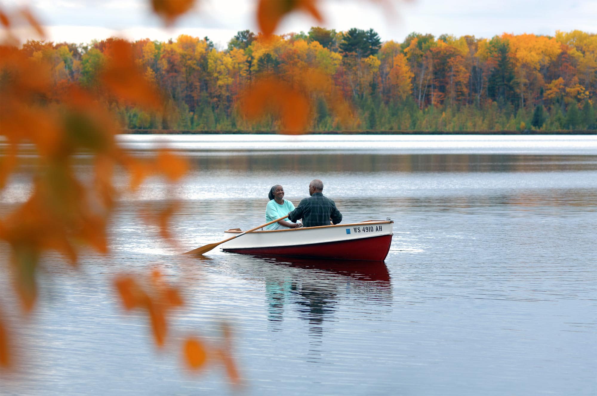 A couple in a boat on a lake.
