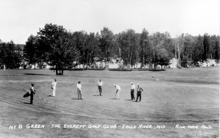 A group of men playing golf.