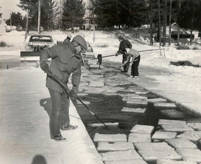 A group of people cleaning ice blocks.