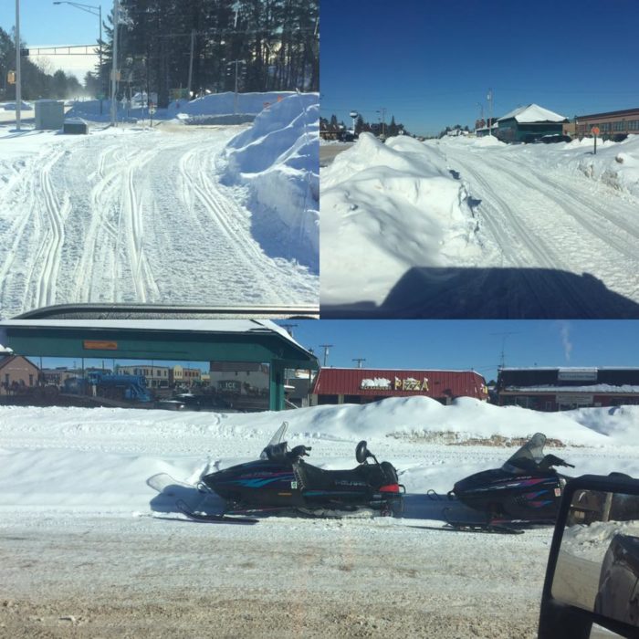 Four pictures of snowmobiles parked on a snowy road.