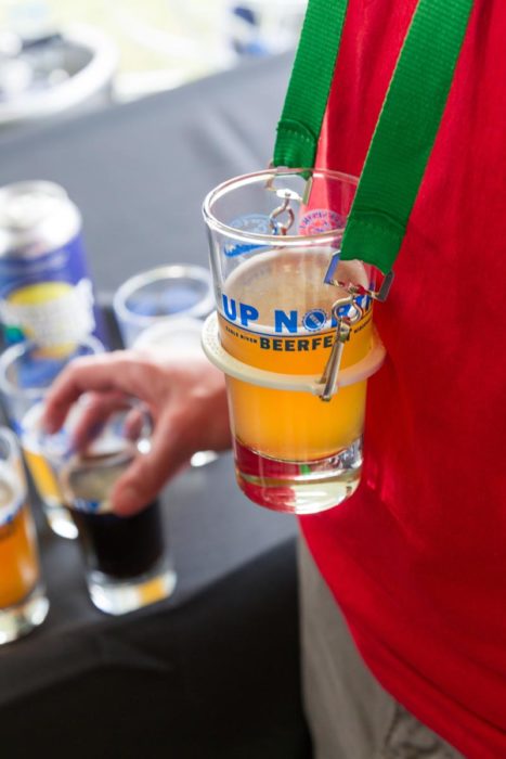 A man holding a glass of beer.