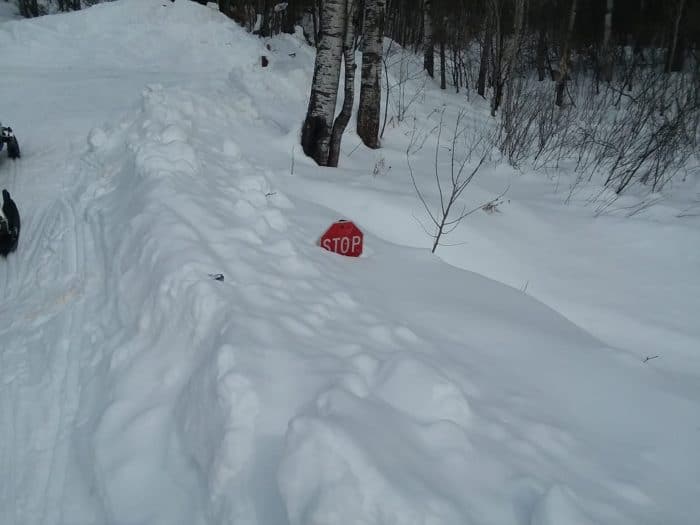 A red stop sign in the snow.