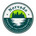 Circular logo with text "Norvado" at the top. Below are silhouettes of trees and a body of water. Text at the bottom reads "Discover the Possibilities, Connecting the Northwoods Since 1950".