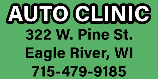 Sign for "AUTO CLINIC" with address 322 W. Pine St., Eagle River, WI, and phone number 715-479-9185 on a green background.