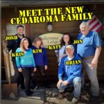 A group of five adults smiles on a wooden deck at Cedaroma Lodge, labeled with their names. Text overhead reads "Meet the new Cedaroma family." An American flag is displayed in the background.