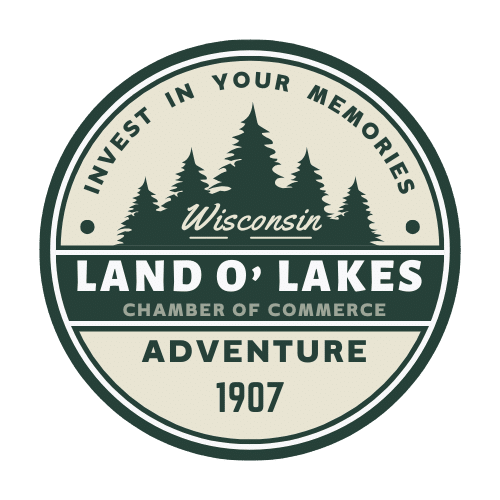 A circular logo featuring the text "Invest in your memories, Wisconsin, Chamber of Commerce, Land O' Lakes, Adventure, 1907" with an image of trees in the center.