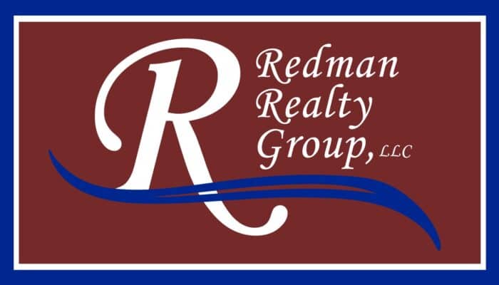 Logo for Redman Realty Group, LLC, featuring a large white "R" with blue swoosh lines on a maroon background and white script text.
