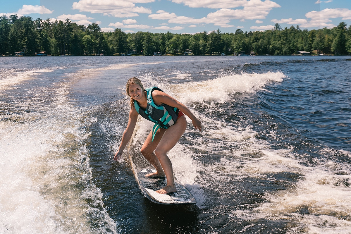 Girl surfing on lake