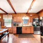 A kitchen with wood paneling and stainless steel appliances.