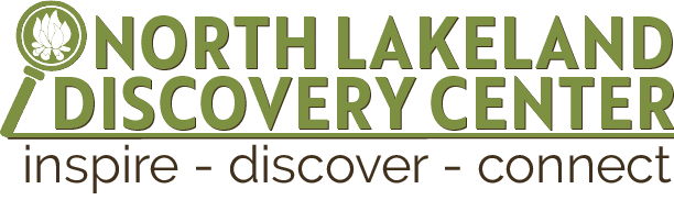 North Lakeland Discovery Center logo with a leaf inside a magnifying glass icon. Text below reads: "inspire - discover - connect.