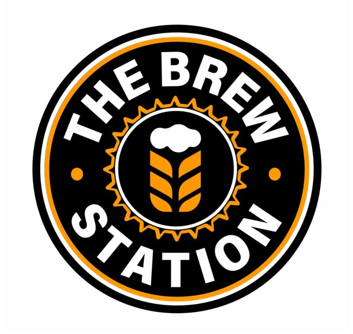 A circular logo for "The Brew Station" with a beer and wheat design in the center, surrounded by a black and orange border.