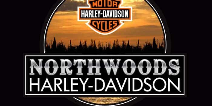 Northwoods Harley-Davidson logo with a sunset and forest silhouette background, located in Arbor Vitae, Wisconsin.