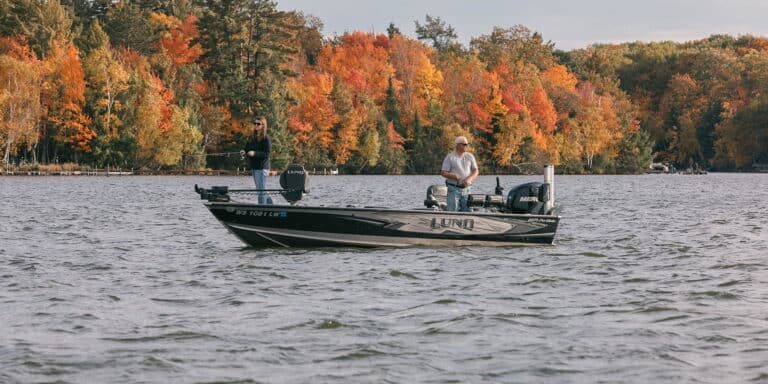 couple on boat in Fall fishing together