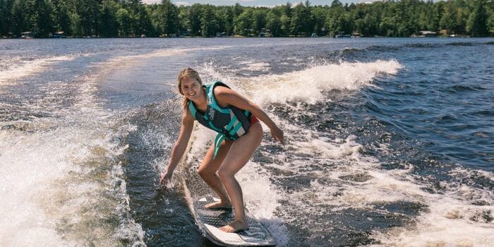 Girl surfing on lake