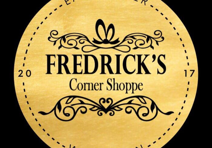 Gold circular logo for "Fredrick's Corner Shoppe," a charming boutique with decorative elements and text "Eagle River, Wisconsin" and "2017.