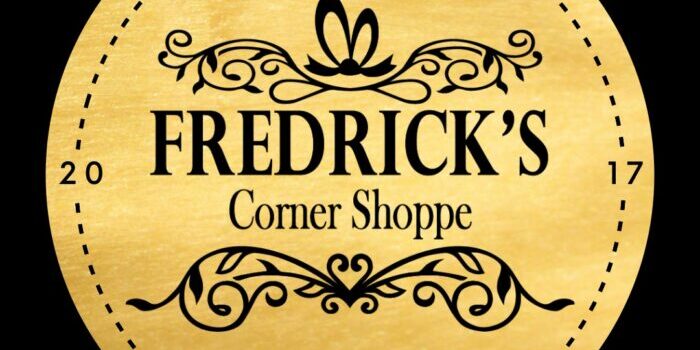 Gold circular logo for "Fredrick's Corner Shoppe," a charming boutique with decorative elements and text "Eagle River, Wisconsin" and "2017.