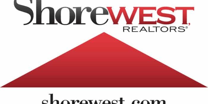 The Shorewest Realtors logo showcases the company name in black and red text above a striking red triangle, with their website shorewest.com elegantly displayed underneath.