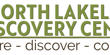 North Lakeland Discovery Center logo with a leaf inside a magnifying glass icon. Text below reads: "inspire - discover - connect.