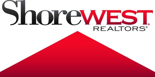 Logo of Shorewest, Realtors featuring the company's name in black and red text above a large red triangular shape, emphasizing their prominence as trusted Realtors.
