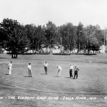 A group of men playing golf.
