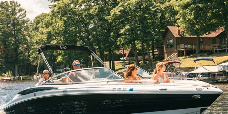 A group of people riding a boat on a lake.